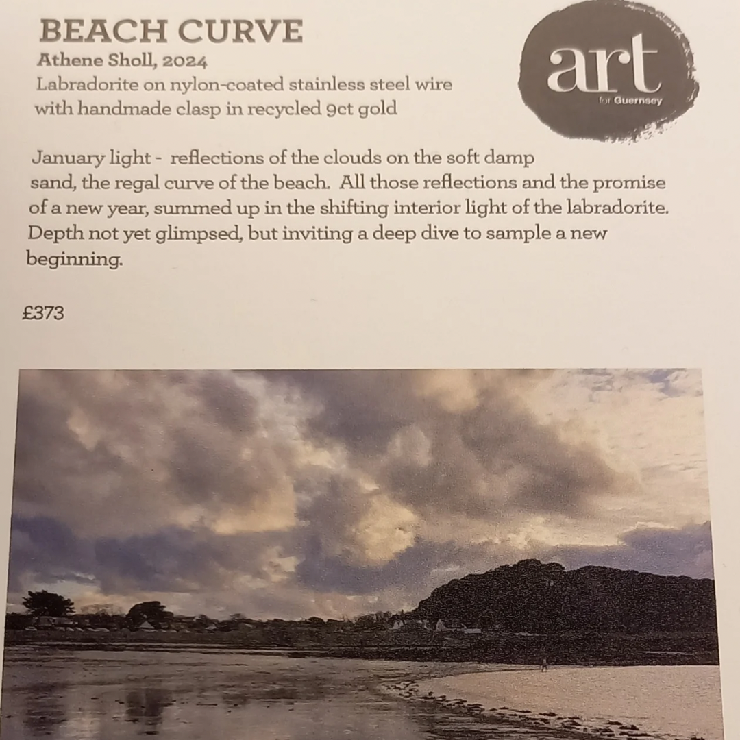 Gallery display board with 'art for Guernsey'  featuring a beach scene and the labradorite gemstone necklace that it inspired. 