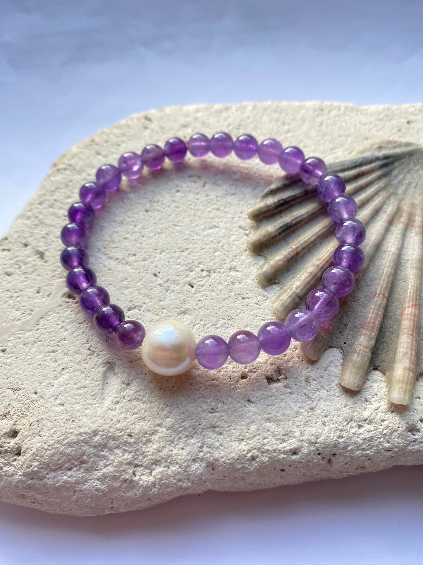 purple amethyst bracelet on a stone background
