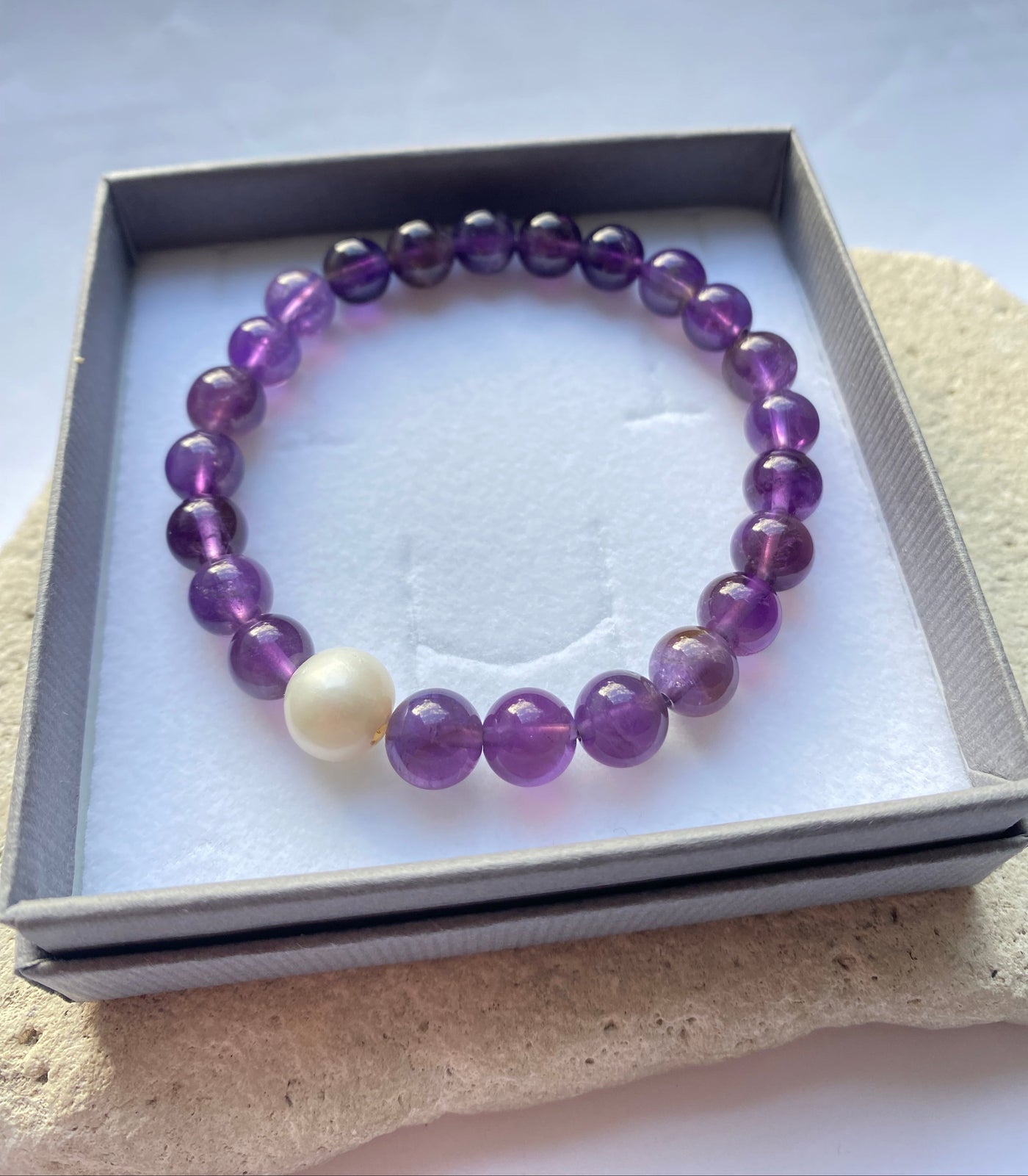 purple amethyst bracelet in a grey gift box