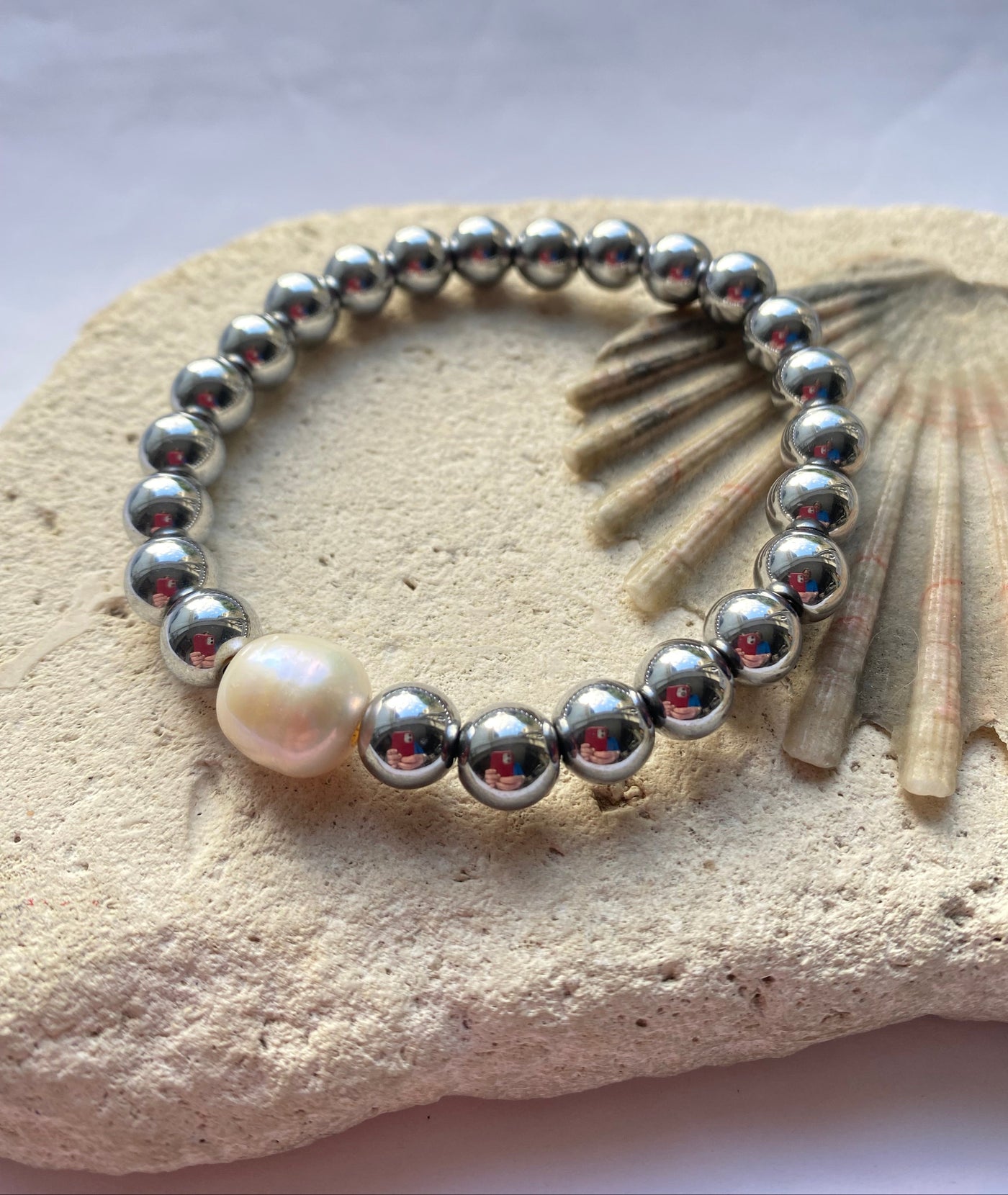 Hematite bead bracelet on a stone background