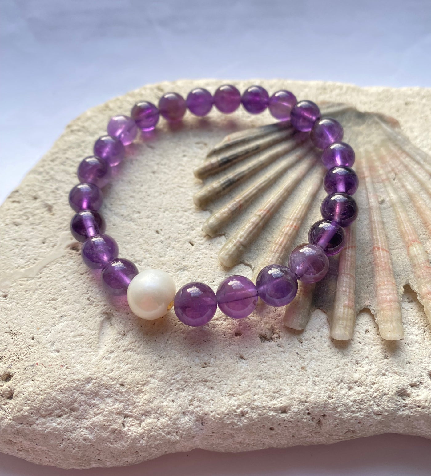 purple amethyst bracelet on a stone background
