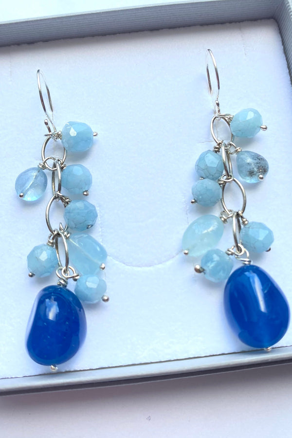 Deep blue chalcedony and pale blue aquamarine beaded gemstone earrings in a  gift box on a white background