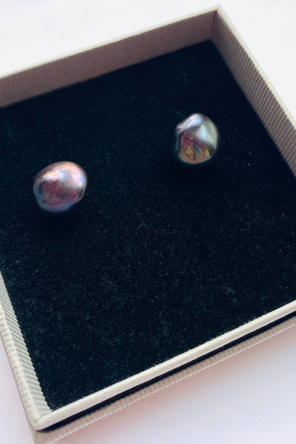 Pair of peacock blue baroque pearl earrings in a gift box on a white background