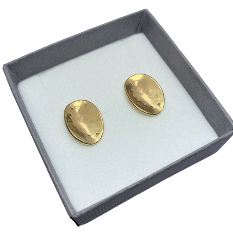 Gold Guernsey ormer shell earrings in a gray box on a white background