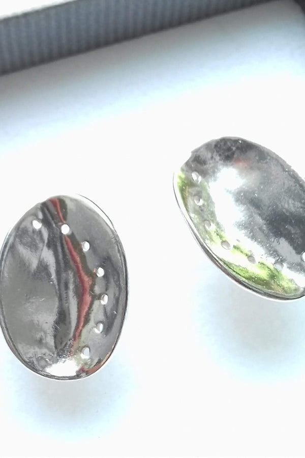 Textured silver guernsey ormer earrings in a gift box on a white background