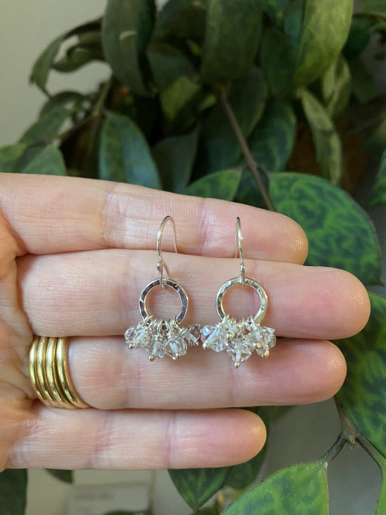 Textured silver earrings with herkimer diamonds suspended in a ruffle