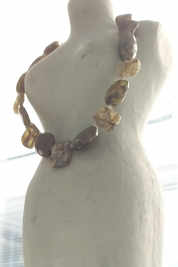 Labradorite gemstone necklace on a mannequin bust in a gallery setting. 