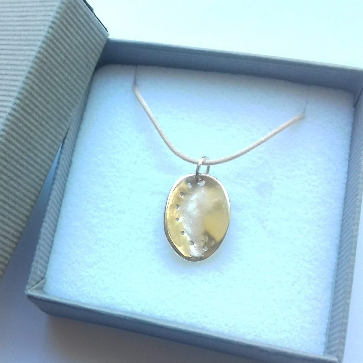 Guernsey ormer shell pendant in 9ct yellow gold on a cotton cord, displaid in a gift box