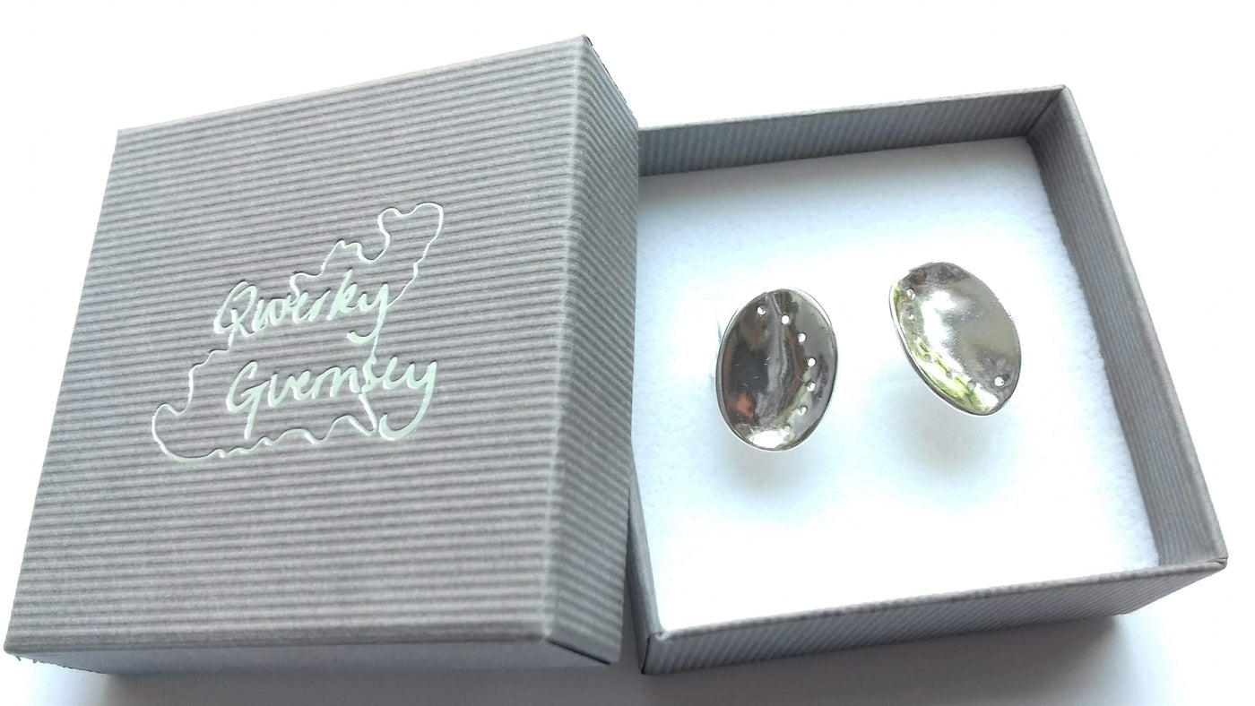 Silver ormer earrings in a 'Qwerky Guernsey' branded box on a white background