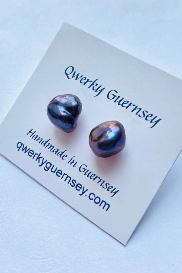 Pair of baroque pearl earrings on a Qwerky Guernsey branded card against a light blue background

