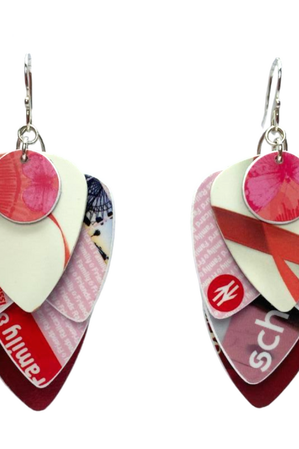 Pair of earrings made from recycled credit and store cards cut into plectrum shapes, on a white background