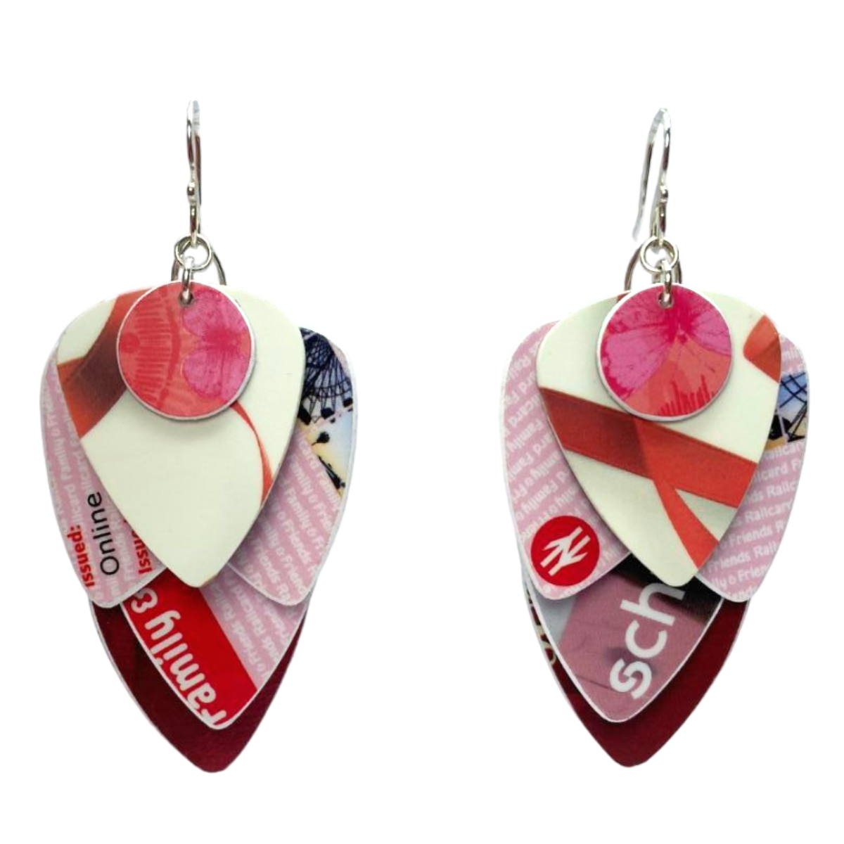 Pair of earrings made from recycled credit and store cards cut into plectrum shapes, on a white background
