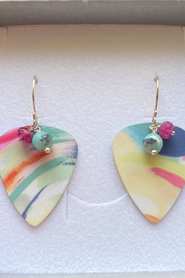 Colorful guitar pick-shaped earrings with rubies and amazonite gemstones in a box