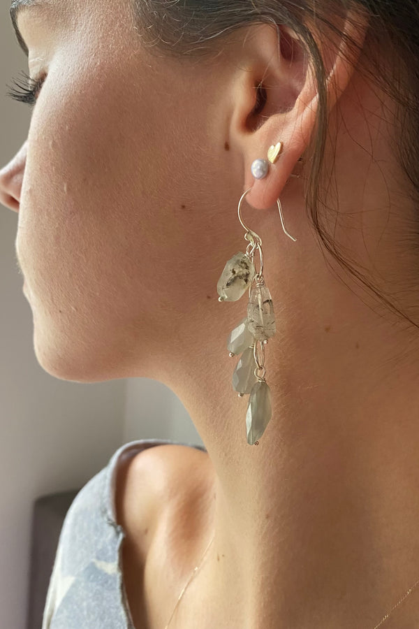 Model wearing beautiful waterfall earrings handmade in sterling silver with luminous moonstones, long and classic styling