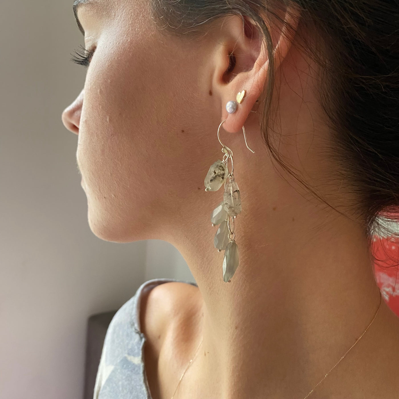 Model wearing beautiful waterfall earrings handmade in sterling silver with luminous moonstones, long and classic styling