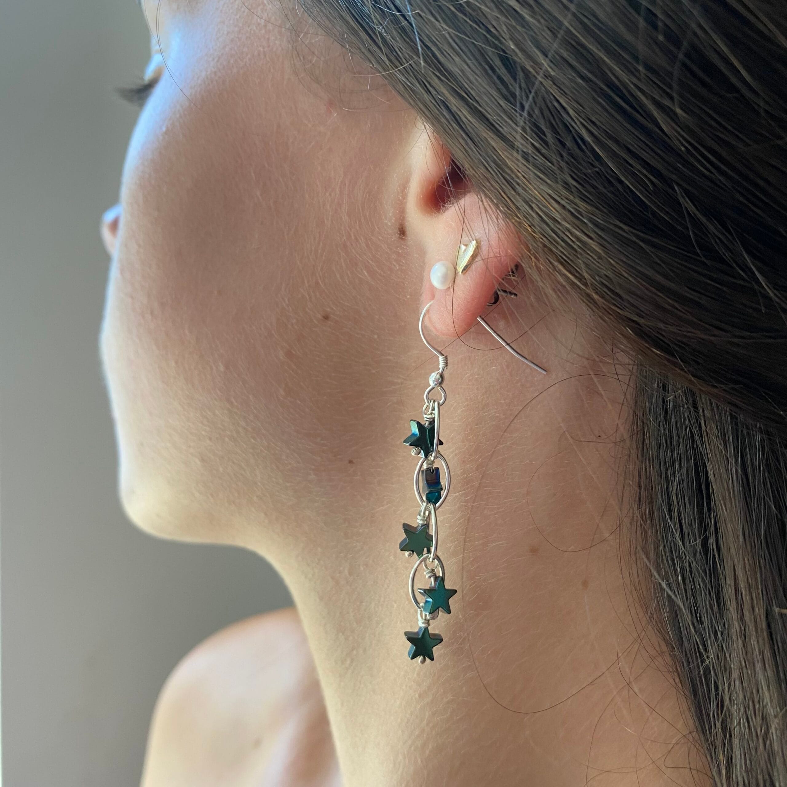 Earrings. 5 green hematite stars on a navette link chain in a waterfall style.