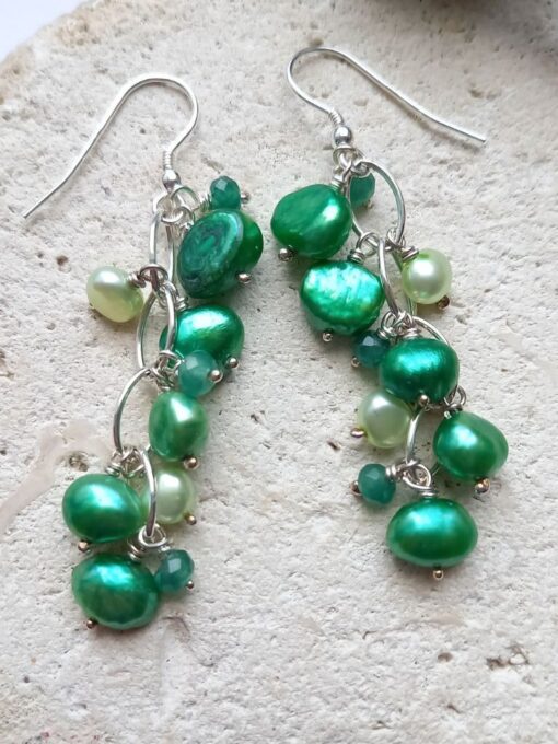 Statement chain earrings with a mixture of emeralds and green pearls.