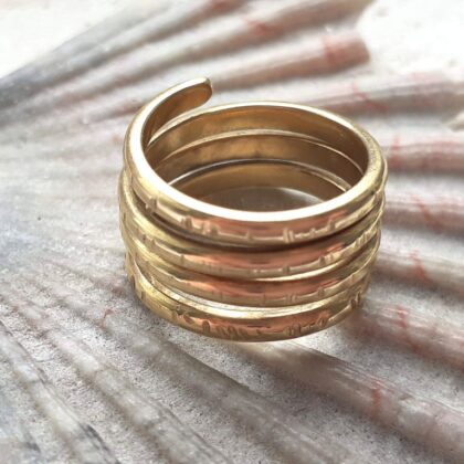 Gold statement twist ring with four rotations.