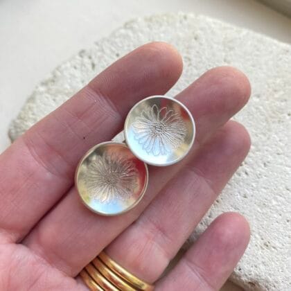 St Peter Port Daisy Stud Earrings, domed silver discs, hand engraved with a freehand daisy design