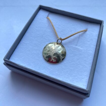 9ct white gold hand engraved disc pendant. Renewal pattern.